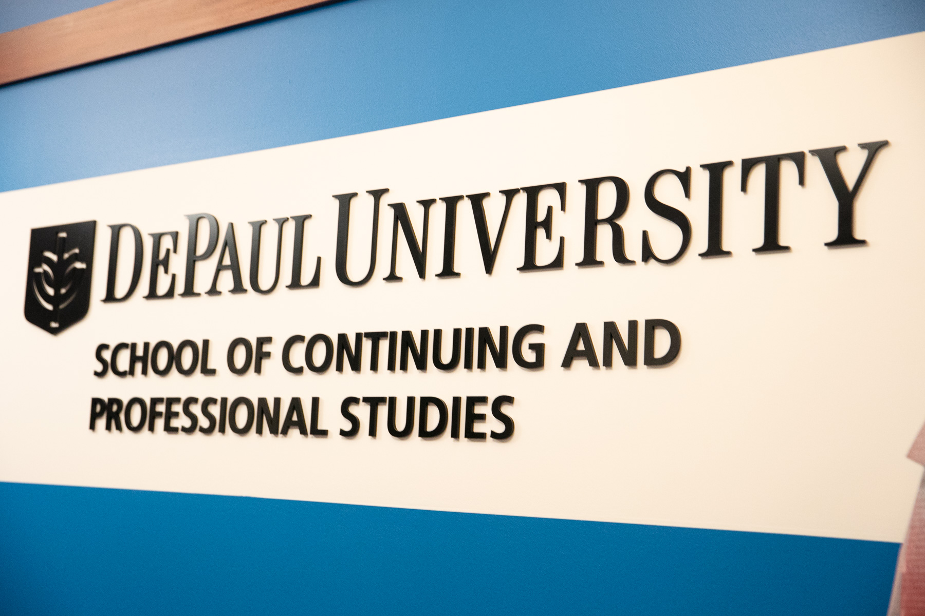 A new sign displaying SCPS's new moniker graces the Daley building's 14th floor lobby. (DePaul University/Randall Spriggs)